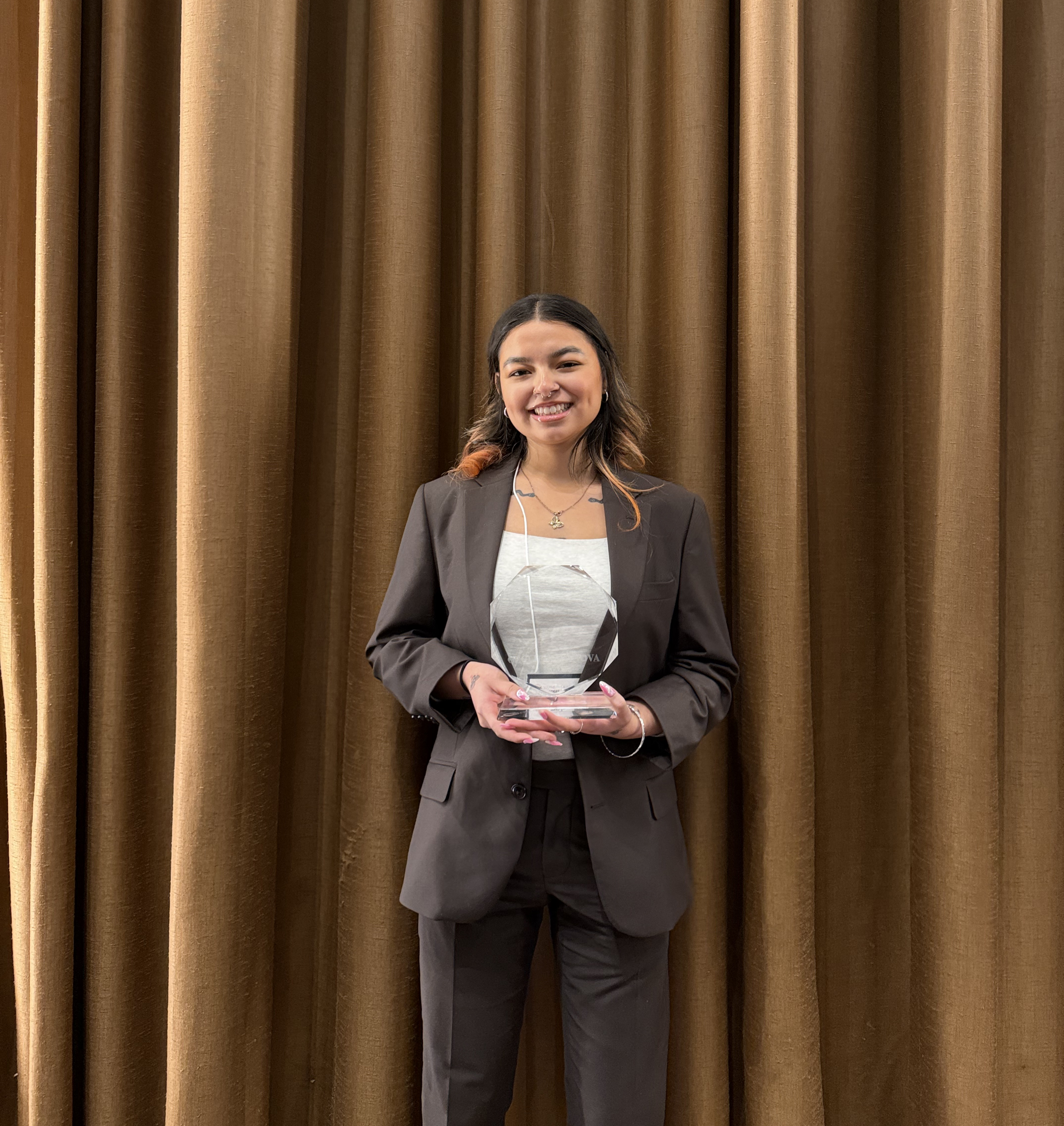 Cycle of Marketing team member holding an award